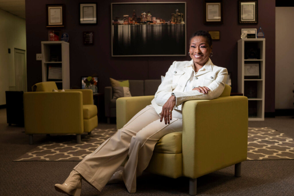 Carla Walker-Miller Poses in a chair for Community Foundation