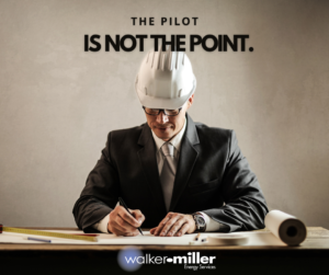 A man with a construction hat and business suit.